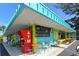 Exterior of a lively bar featuring colorful tables and chairs, and a blackboard menu at 7808 20Th W Pl, Bradenton, FL 34209