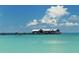 Picturesque scene featuring a pier with buildings, turquoise waters, and a partially cloudy sky at 7808 20Th W Pl, Bradenton, FL 34209