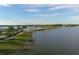 Aerial view showing a community with lakefront property and lush landscaping at 7876 Grande Shores Dr, Sarasota, FL 34240