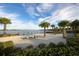 Relaxing beach access with lounge chairs, offering scenic lake views at 7876 Grande Shores Dr, Sarasota, FL 34240