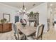 Elegant dining room featuring a large wooden table, chandelier, and built-in hutch at 7876 Grande Shores Dr, Sarasota, FL 34240