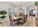 Formal dining room with large table, chandelier, and rug at 7876 Grande Shores Dr, Sarasota, FL 34240