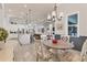 Elegant dining room features a rustic wood table and chandelier at 7876 Grande Shores Dr, Sarasota, FL 34240