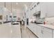 Bright kitchen features white cabinets, quartz countertops, and a large island at 7876 Grande Shores Dr, Sarasota, FL 34240