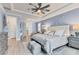 Serene main bedroom with king-size bed, plush bedding, and a ceiling fan at 7876 Grande Shores Dr, Sarasota, FL 34240