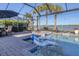 Relaxing pool area with swim-up lounge chairs and lake view at 7876 Grande Shores Dr, Sarasota, FL 34240