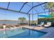 Relaxing pool and lanai with lake view, screened enclosure, and lounge chairs at 7876 Grande Shores Dr, Sarasota, FL 34240