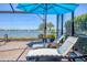 Enjoy the lake view from comfortable loungers by the pool at 7876 Grande Shores Dr, Sarasota, FL 34240