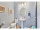 Stylish powder room with pedestal sink and updated fixtures at 7876 Grande Shores Dr, Sarasota, FL 34240