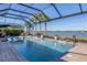 Inviting swimming pool with spa and screened enclosure at 7876 Grande Shores Dr, Sarasota, FL 34240