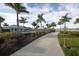 Scenic walkway with lush landscaping and pool views at 7876 Grande Shores Dr, Sarasota, FL 34240