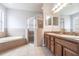 Bathroom featuring double vanity sinks, shower stall, and soaking tub at 11715 Summer Springs Dr, Riverview, FL 33579