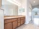 Bathroom with double sink vanity, large mirror and tile flooring at 11715 Summer Springs Dr, Riverview, FL 33579