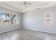 Spacious bedroom featuring a ceiling fan and ample natural light from large windows at 11715 Summer Springs Dr, Riverview, FL 33579