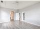Bright bedroom features a ceiling fan, archway, closet, and doorway to patio at 11715 Summer Springs Dr, Riverview, FL 33579