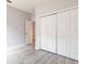 Bedroom with closet, light gray paint and gray wood-look tile flooring at 11715 Summer Springs Dr, Riverview, FL 33579