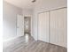 Bedroom features closet, door to outside and light gray wood-look tile flooring at 11715 Summer Springs Dr, Riverview, FL 33579