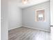 This bedroom features a window letting in natural light and wood-look tile flooring at 11715 Summer Springs Dr, Riverview, FL 33579