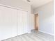 Bedroom features closet, fresh paint and light gray wood-look tile flooring at 11715 Summer Springs Dr, Riverview, FL 33579