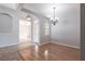 Elegant dining room space with chandelier, an archway, and hardwood flooring at 11715 Summer Springs Dr, Riverview, FL 33579