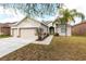 Charming single-story home featuring a well-manicured lawn and attached two-car garage at 11715 Summer Springs Dr, Riverview, FL 33579