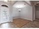 Inviting foyer with decorative front door, chandelier lighting, and tile and wood flooring at 11715 Summer Springs Dr, Riverview, FL 33579