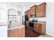 Modern kitchen with stainless steel appliances, a breakfast bar, and wooden cabinets at 11715 Summer Springs Dr, Riverview, FL 33579