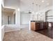 Open kitchen and living space with modern pendant lights and sleek breakfast bar at 11715 Summer Springs Dr, Riverview, FL 33579
