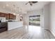 Bright open floor plan with wood floors, stainless appliances, and sliding glass doors to the backyard at 11715 Summer Springs Dr, Riverview, FL 33579