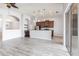 Open-concept living area with wood floors, modern lighting, and a breakfast bar overlooking the kitchen at 11715 Summer Springs Dr, Riverview, FL 33579