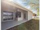 Angle view of the covered patio featuring sliding glass doors and the home's backyard at 11715 Summer Springs Dr, Riverview, FL 33579