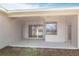 View of the covered patio area featuring sliding glass doors and a large window at 11715 Summer Springs Dr, Riverview, FL 33579