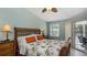Bright bedroom with a comfortable queen-size bed and access to a private balcony at 1228 Siesta Bayside Dr # 1228-C, Sarasota, FL 34242