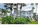 Two-story home with gray siding, metal roof, and lush landscaping at 1228 Siesta Bayside Dr # 1228-C, Sarasota, FL 34242