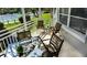 Screened lanai with outdoor furniture, overlooking a resort-style pool and tennis courts at 1228 Siesta Bayside Dr # 1228-C, Sarasota, FL 34242