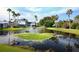 Peaceful waterfront view with lush landscaping and a tranquil fountain at 1228 Siesta Bayside Dr # 1228-C, Sarasota, FL 34242