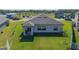 Single-story home with backyard, covered patio, and surrounding community view at 13608 Sunset Sapphire Ct, Parrish, FL 34219