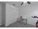 Bright bedroom with ceiling fan, double closet, and workspace at 13608 Sunset Sapphire Ct, Parrish, FL 34219
