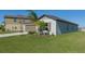 Single story home with brown garage door and lush green landscaping at 13608 Sunset Sapphire Ct, Parrish, FL 34219