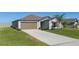 House exterior with driveway and landscaping at 13608 Sunset Sapphire Ct, Parrish, FL 34219