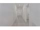 Long hallway with light gray tile flooring at 13608 Sunset Sapphire Ct, Parrish, FL 34219