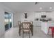 Bright kitchen with white cabinets, stainless steel appliances, and an island at 13608 Sunset Sapphire Ct, Parrish, FL 34219