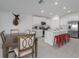 Open concept kitchen with white cabinets, island, and stainless steel appliances at 13608 Sunset Sapphire Ct, Parrish, FL 34219