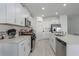 Modern kitchen with white cabinets, quartz countertops, and stainless steel appliances at 13608 Sunset Sapphire Ct, Parrish, FL 34219