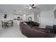 Spacious living room with a large sectional sofa and ceiling fan at 13608 Sunset Sapphire Ct, Parrish, FL 34219