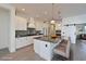 Modern kitchen with white cabinets, large island, and stainless steel appliances at 13619 Old Creek Ct, Parrish, FL 34219