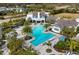 Community pool with lounge chairs and palm trees at 13619 Old Creek Ct, Parrish, FL 34219