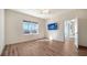 Bedroom with wood-look floors, a ceiling fan, and access to a balcony at 14155 Campfire Ct, Parrish, FL 34219