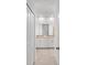 Bright bathroom with double vanity, tile floor, and linen closet at 14824 Lyla Ter, Bradenton, FL 34211