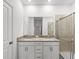 Modern bathroom with double vanity, granite countertop, and a large shower at 14824 Lyla Ter, Bradenton, FL 34211